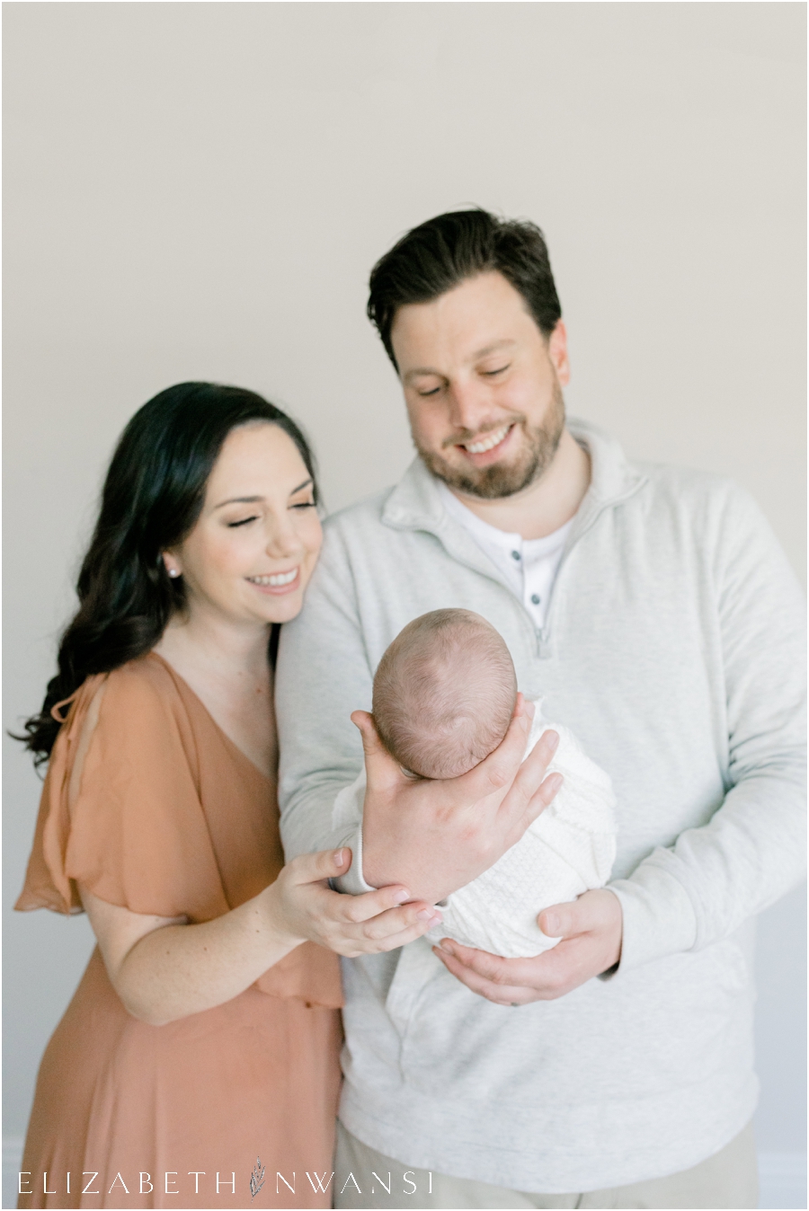 Mom and Dad Holding Newborn Photography